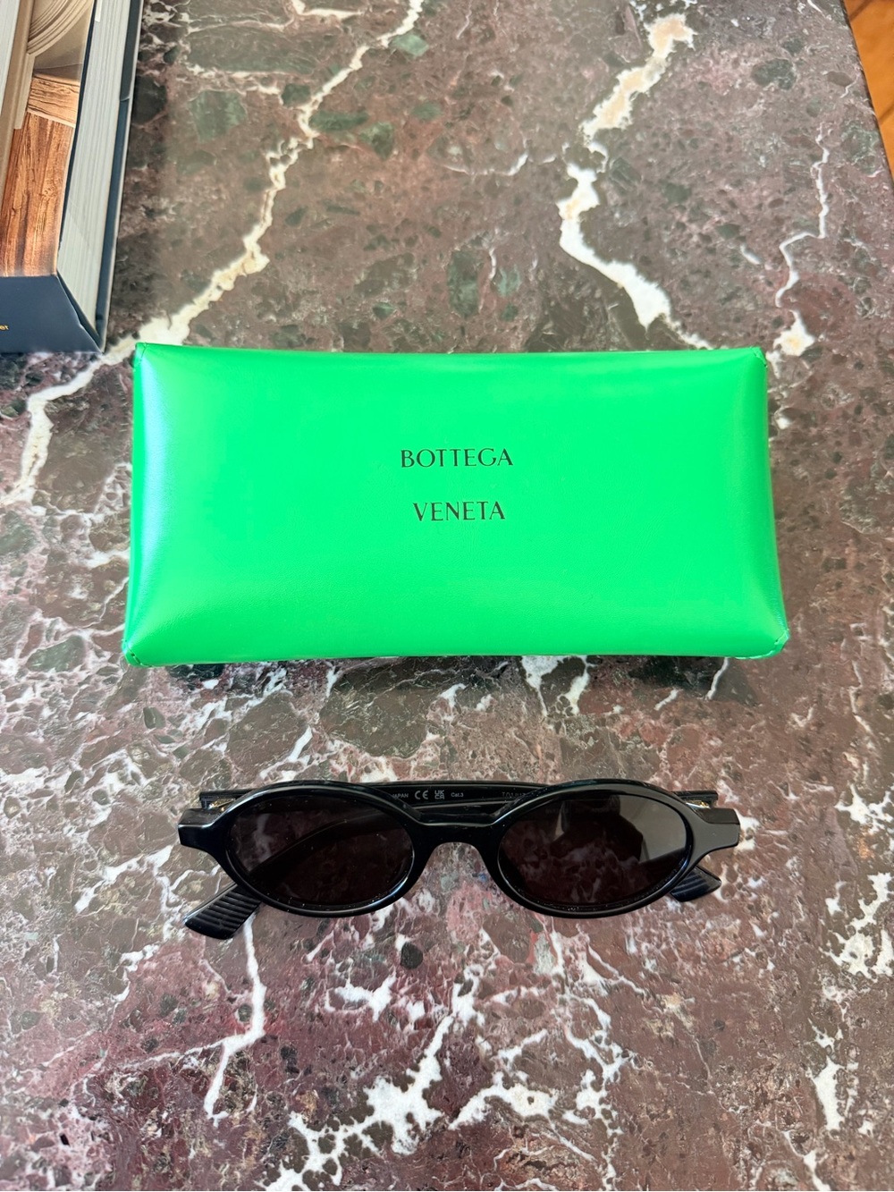 Bottega Veneta Black Oval Sunglasses with Bright Green Case